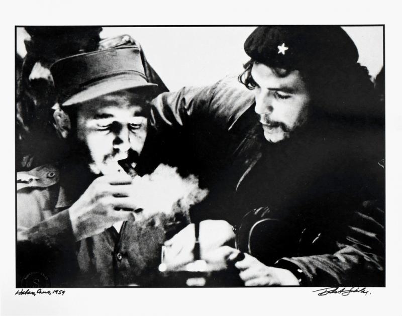 The famous photograph of Fidel Castro and Ernesto "Che" Guevara planning in the middle of the night. Salas made the photo using only the light of a match as Castro lit is cigar.